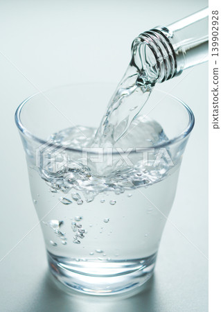 Pour bottled mineral water into a glass. No. 3 Pour bottled mineral water into a glass. No. 3 139902928