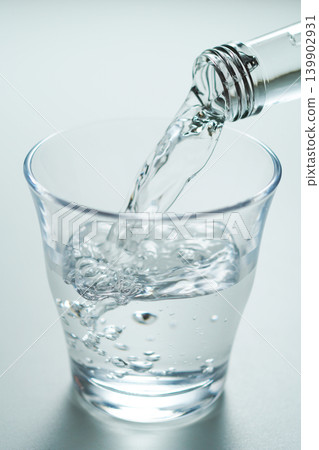 Pour bottled mineral water into a glass. No. 3 Pour bottled mineral water into a glass. No. 3 139902931