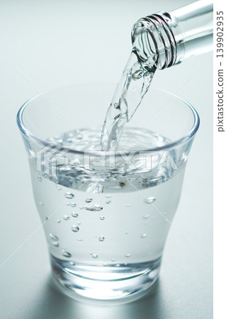 Pour bottled mineral water into a glass. No. 3 Pour bottled mineral water into a glass. No. 3 139902935