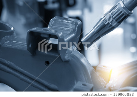 Close-up of high-precision advanced laser welding process on motorcycle parts with bright sparks and lighting effects. Close-up of high-precision advanced laser welding process on motorcycle parts with bright sparks and lighting effects. 139903888