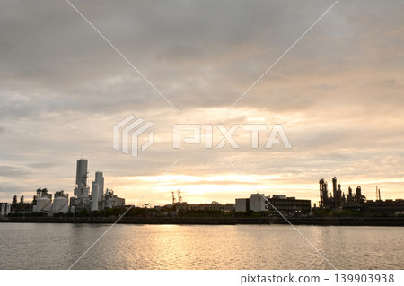 A panoramic industrial landscape of the harbor and factory complex at dusk. A panoramic industrial landscape of the harbor and factory complex at dusk. 139903938