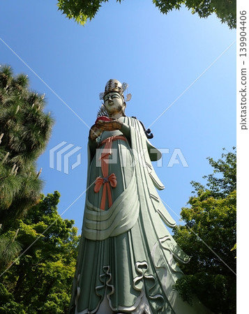 Kannon statue against the blue sky Kannon statue against the blue sky 139904406