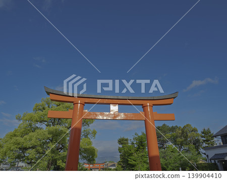 A crimson gate to a sacred realm, enveloped in a vast azure sky. A crimson gate to a sacred realm, enveloped in a vast azure sky. 139904410