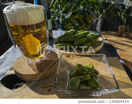 Beer sparkling in the early summer light, a blissful evening drink. Beer sparkling in the early summer light, a blissful evening drink. 139904414