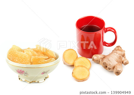 Healthy ginger tea with fresh root slices and candied ginger pieces. Healthy ginger tea with fresh root slices and candied ginger pieces. 139904949