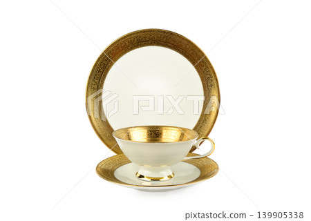 Luxury vintage porcelain teacup set with intricate gold filigree patterns. Luxury vintage porcelain teacup set with intricate gold filigree patterns. 139905338