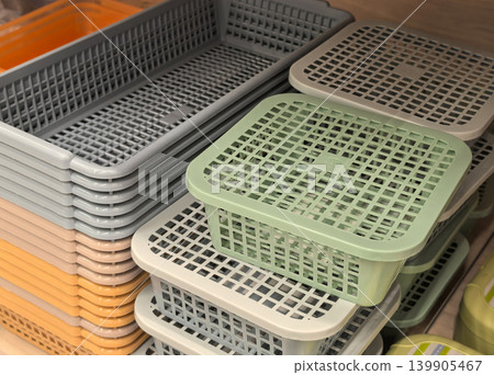 Stacked plastic mesh baskets in pastel colors at organization store display Stacked plastic mesh baskets in pastel colors at organization store display 139905467