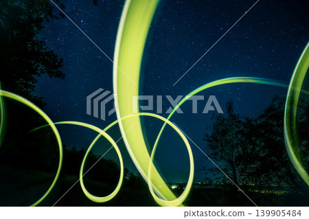 Bright Green Flashlight Trails Creating Vivid Glowing Lines In Darkness Bright Green Flashlight Trails Creating Vivid Glowing Lines In Darkness 139905484