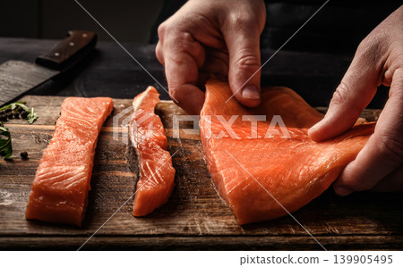 Chief cooking salmon red fish fillet in the kitchen Chief cooking salmon red fish fillet in the kitchen 139905495