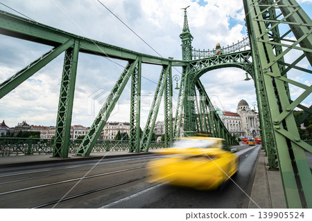 Rushing Yellow Taxi Car Driving Fast By Bridge Over Danube In Bu Rushing Yellow Taxi Car Driving Fast By Bridge Over Danube In Bu 139905524