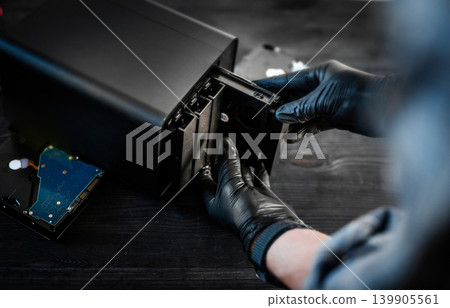 Gloved Hands Inserting Hdd Hard Disk Drive Into Desktop Das Storage System For Files Gloved Hands Inserting Hdd Hard Disk Drive Into Desktop Das Storage System For Files 139905561