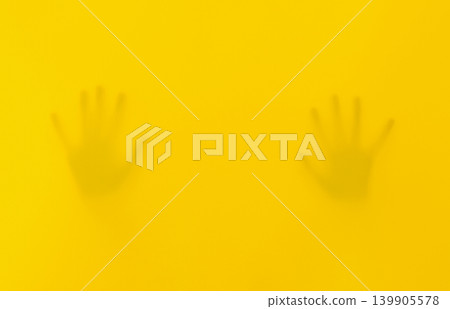 Silhouettes Of Hands Behind Yellow Fabric Silhouettes Of Hands Behind Yellow Fabric 139905578