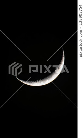 Waxing crescent Moon with crisp cratered relief against night sky Waxing crescent Moon with crisp cratered relief against night sky 139905754