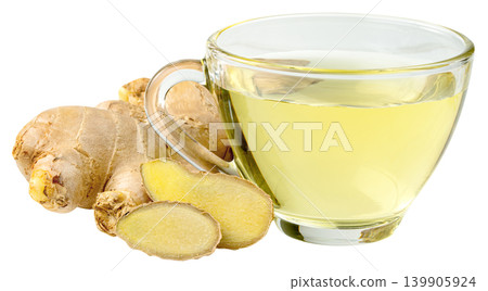 Glass cup of hot ginger tea with fresh ginger root and slices isolated. Healthy herbal beverage for detox and wellness. Natural medicine and organic drink concept. Glass cup of hot ginger tea with fresh ginger root and slices isolated. Healthy herbal beverage for detox and wellness. Natural medicine and organic drink concept. 139905924