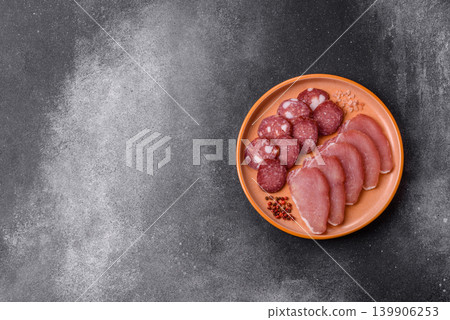 Smoked or dry cured salami slices or ham with salt and spices. Smoked sausage Smoked or dry cured salami slices or ham with salt and spices. Smoked sausage 139906253
