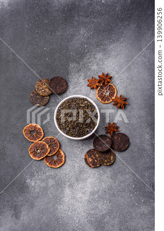 Granules of dried organic Chinese green tea with herbal additives. Dry green tea Granules of dried organic Chinese green tea with herbal additives. Dry green tea 139906256