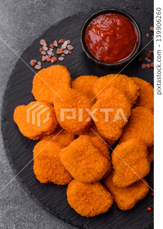Fried chicken nuggets with sauce, salt, and spices, fast food, unhealthy food. Chicken nuggets Fried chicken nuggets with sauce, salt, and spices, fast food, unhealthy food. Chicken nuggets 139906260