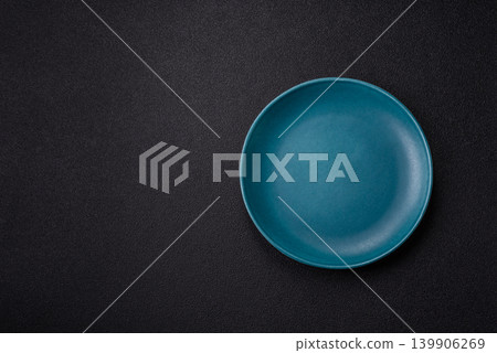 An empty ceramic round plate, kitchen utensils for a dinner table. An empty plate An empty ceramic round plate, kitchen utensils for a dinner table. An empty plate 139906269