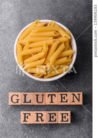 Italian uncooked, dry, gluten free penne pasta, ready for cooking. Dry, gluten free penne pasta Italian uncooked, dry, gluten free penne pasta, ready for cooking. Dry, gluten free penne pasta 139906283
