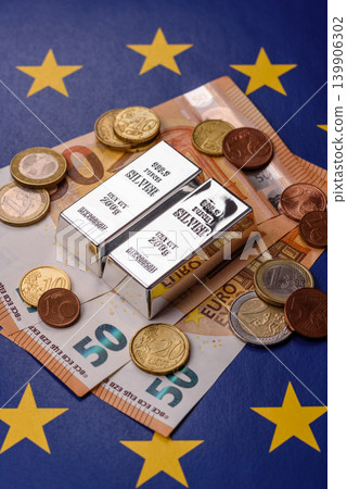 A silver bar, white metal against a backdrop of EU flag, as a concept. A silver bar A silver bar, white metal against a backdrop of EU flag, as a concept. A silver bar 139906302