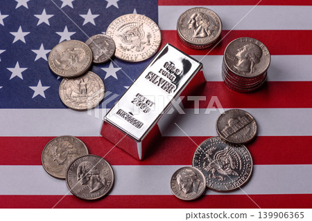 A silver bar, white metal against a backdrop of USA flag, as a concept. A silver bar A silver bar, white metal against a backdrop of USA flag, as a concept. A silver bar 139906365