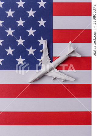 An airplane on the US flag as a conceptual backdrop for flights and travel. An airplane on the flag An airplane on the US flag as a conceptual backdrop for flights and travel. An airplane on the flag 139906378