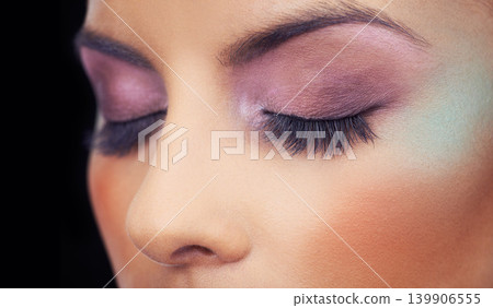 Eyes, makeup and woman with colorful and creative beauty in studio and black background. Unique, cosmetics and model with bold eyeshadow aesthetic on face to glow or shine with confidence in identity Eyes, makeup and woman with colorful and creative beauty in studio and black background. Unique, cosmetics and model with bold eyeshadow aesthetic on face to glow or shine with confidence in identity 139906555