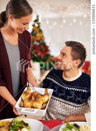 Happy, Christmas and couple with dinner at party in dining room of modern home for celebration. Smile, festive and young man and woman with chicken and vegetables meal for xmas event at house. 139906631