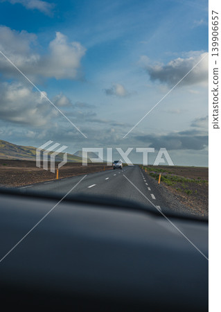 Straight Road Through Rocky Terrain with Vehicle in Iceland 139906657