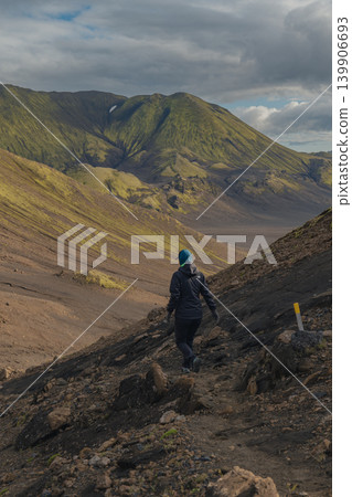 Hiker on Rocky Trail in Volcanic Landscape of Iceland Hiker on Rocky Trail in Volcanic Landscape of Iceland 139906693