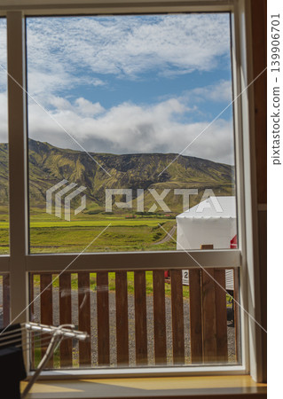 Lush Green Valley and Rugged Hills Framed by a Window in Iceland 139906701