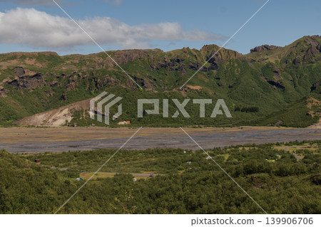 Lush Green Valley with Rocky Hills and Sparse Vegetation in Iceland 139906706