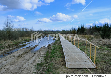 Wooden Boardwalk Alongside Muddy Path in Yelnya Nature Reserve 139906748
