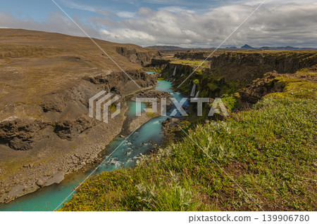Turquoise River and Waterfalls in an Icelandic Canyon with Mountains 139906780
