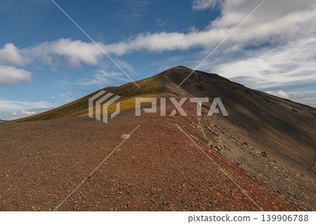 Rugged Volcanic Ridge with Moss in Iceland Under Partly Cloudy Sky Rugged Volcanic Ridge with Moss in Iceland Under Partly Cloudy Sky 139906788