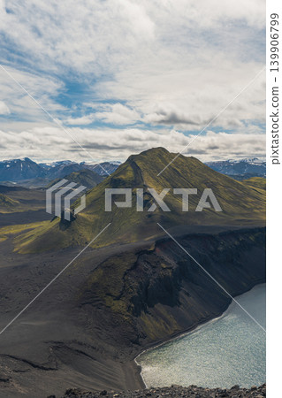 Green Covered Mountain and Lake in Volcanic Icelandic Landscape Green Covered Mountain and Lake in Volcanic Icelandic Landscape 139906799