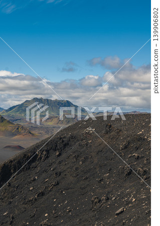 Volcanic Landscape with Green Mountain and Snow Streaks in Iceland Volcanic Landscape with Green Mountain and Snow Streaks in Iceland 139906802