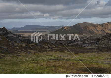 Moss Covered Volcanic Rocks and Multicolored Mountains in Iceland 139906853