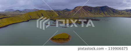 Aerial View of Icelandic Lake with Moss Covered Hills and Volcanic Mountains Aerial View of Icelandic Lake with Moss Covered Hills and Volcanic Mountains 139906875