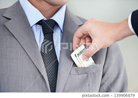 Businessman, hands and bribe with cash for fraud, payment or deal on a white studio background. Closeup of man or employee taking money, dollar bill or paper in scam, secret or bribery from colleague Businessman, hands and bribe with cash for fraud, payment or deal on a white studio background. Closeup of man or employee taking money, dollar bill or paper in scam, secret or bribery from colleague 139906879