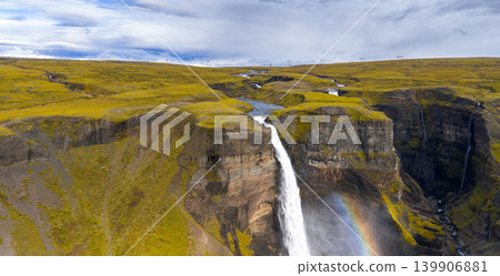 Aerial View of Icelandic Waterfall with Rainbow and Volcanic Terrain Aerial View of Icelandic Waterfall with Rainbow and Volcanic Terrain 139906881