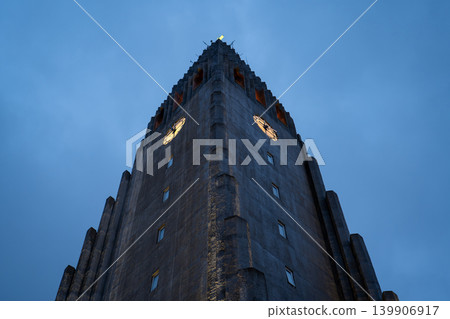 Hallgrimskirkja Facade Illuminated Against a Dusky Blue Sky Hallgrimskirkja Facade Illuminated Against a Dusky Blue Sky 139906917
