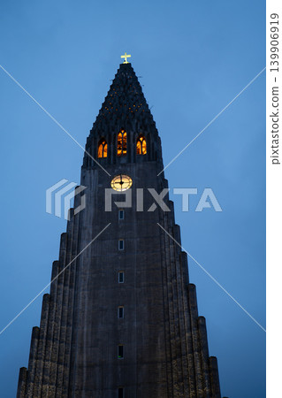 Hallgrimskirkja Church Illuminated Against a Dusky Blue Sky Hallgrimskirkja Church Illuminated Against a Dusky Blue Sky 139906919