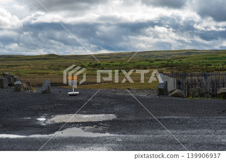 Rural Icelandic Landscape with Gravel Parking Area and Yellow Sign Rural Icelandic Landscape with Gravel Parking Area and Yellow Sign 139906937