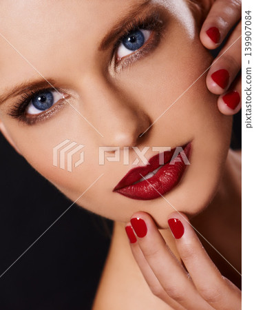 Portrait, makeup and manicure with woman isolated on dark background for cosmetics or satisfaction. Salon, red lipstick and nail polish with confident young model in studio for beauty or wellness Portrait, makeup and manicure with woman isolated on dark background for cosmetics or satisfaction. Salon, red lipstick and nail polish with confident young model in studio for beauty or wellness 139907084