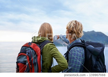 Hiking, nature and couple on mountain pointing with backpack for freedom, trekking or explore landscape. Travel, dating and man and woman hug by scenic view on holiday, vacation and outdoor adventure Hiking, nature and couple on mountain pointing with backpack for freedom, trekking or explore landscape. Travel, dating and man and woman hug by scenic view on holiday, vacation and outdoor adventure 139907088
