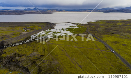 Aerial View of Icelandic Lake, Dam, Waterfall, and Mossy Terrain Aerial View of Icelandic Lake, Dam, Waterfall, and Mossy Terrain 139907101