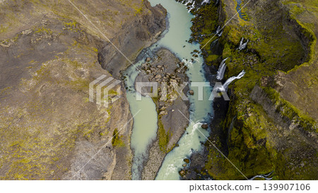 Aerial View of Milky Blue River and Waterfalls in Icelandic Gorge Aerial View of Milky Blue River and Waterfalls in Icelandic Gorge 139907106