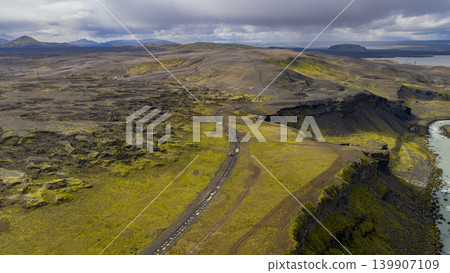 Aerial View of Icelandic Volcanic Terrain with Winding Road and Cliffs Aerial View of Icelandic Volcanic Terrain with Winding Road and Cliffs 139907109