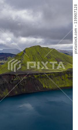 Aerial View of Moss Covered Volcanic Hill and Crater Lake in Iceland Aerial View of Moss Covered Volcanic Hill and Crater Lake in Iceland 139907128